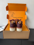 Louis Vuitton women's sneakers rear view with dark purple uppers and tan-white heel panels