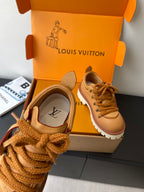 Women’s Louis Vuitton tan leather sneakers close-up, lace and brand logo detail.