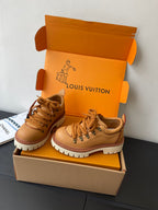 Women’s Louis Vuitton tan lace-up sneakers pair on display, 3/4 view.