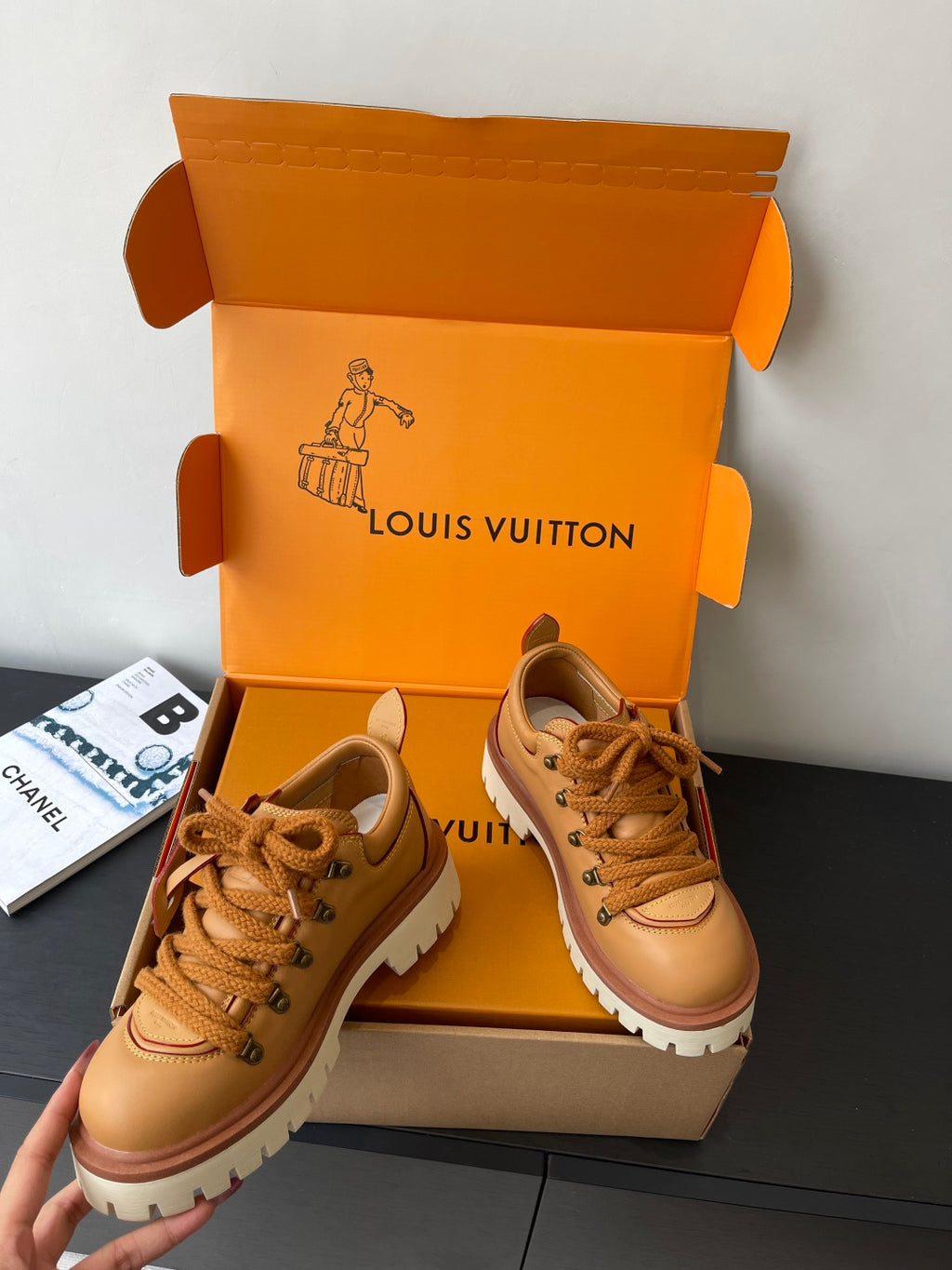 Women’s Louis Vuitton tan lace-up sneakers, angled view with thick white outsole.