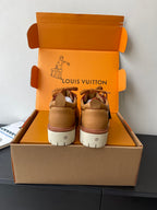 Women’s Louis Vuitton tan sneakers, back view with white midsole and lace-up front.