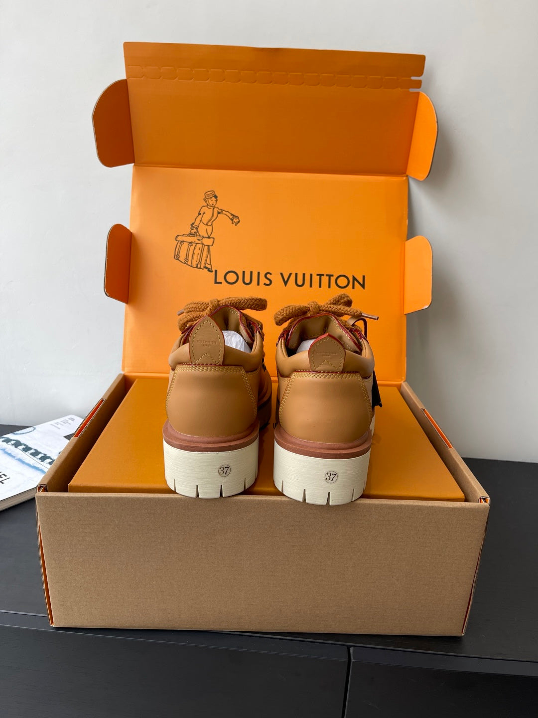 Women’s Louis Vuitton tan sneakers, back view with white midsole and lace-up front.