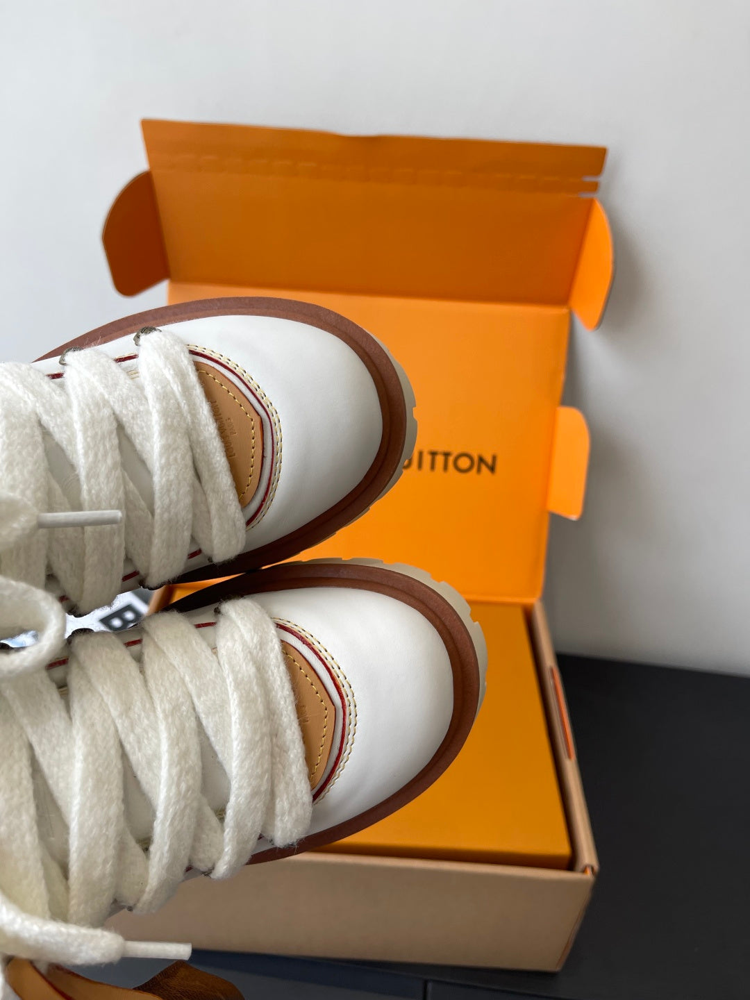 Louis Vuitton women's white sneaker heel and laces, brown-trimmed sole