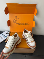 Louis Vuitton women's white lace-up sneakers with brown trim, two shoes view
