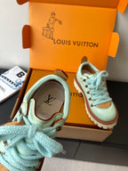 Women's mint sneaker close-up with blue laces, brown collar trim, LV logo