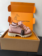 Pink Louis Vuitton sneakers, side view with lace-up closure and brown monogram panel