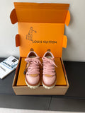Pink leather-style Louis Vuitton sneakers with lace-up front and white lug sole