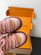 Pink Louis Vuitton sneakers close-up of toe cap and lace with tan edge trim
