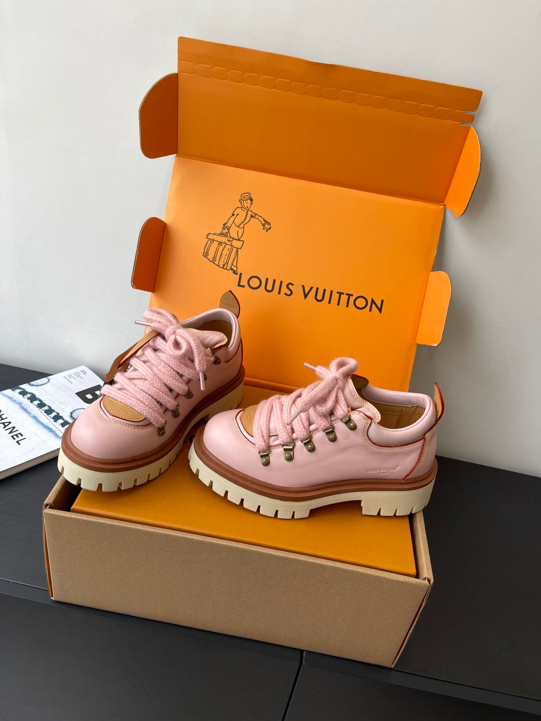 Pink Louis Vuitton sneakers, front angled view with lace-up closure and white lug sole