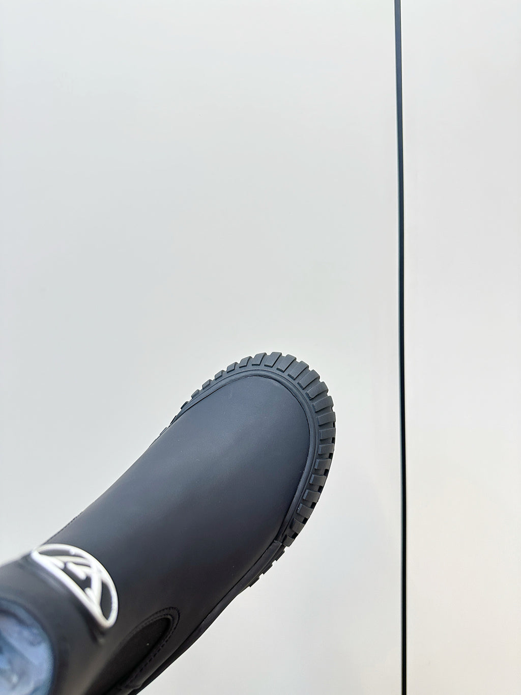 Dark navy ankle boot toe and textured rubber sole with deep tread