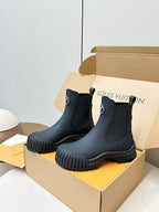 Navy leather ankle boots with elastic gore, pull tabs, and chunky ridged sole