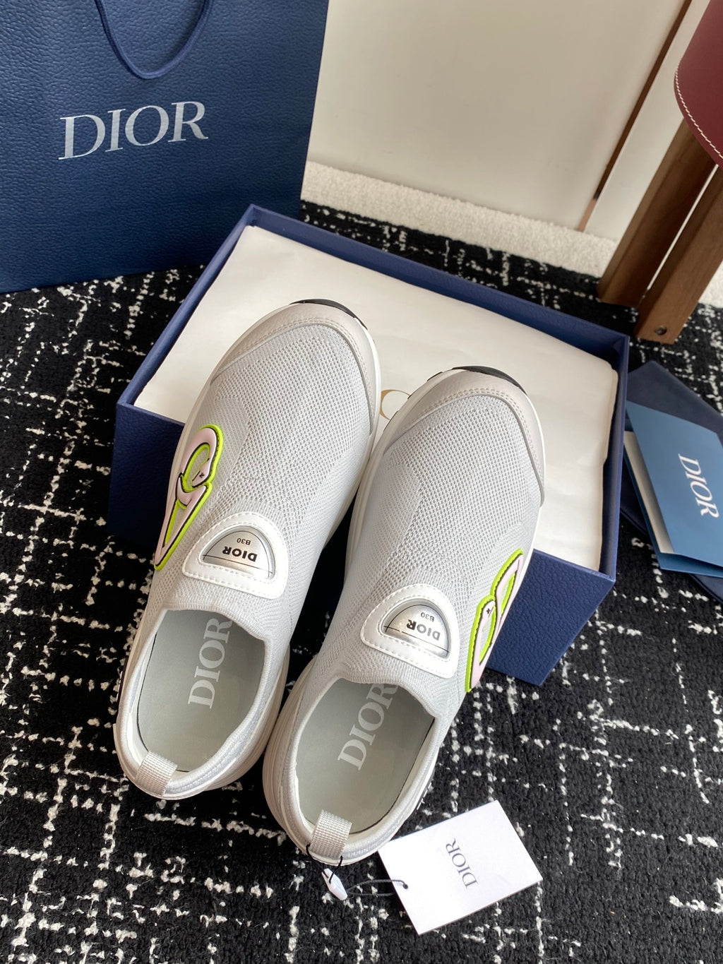 White slip-on sneakers with textured upper, Dior logo patch, neon-green accent