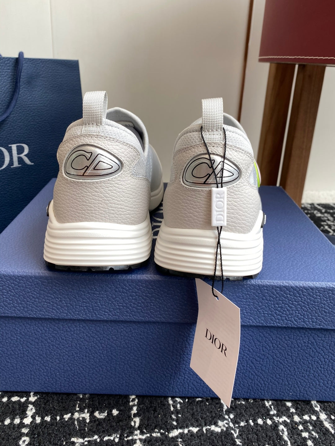White back view slip-on sneakers with neon-green logo and Dior branding