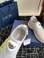 White slip-on sneakers showing inner sole label and neon-green logo detail