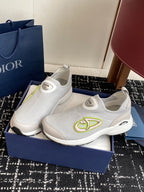 Pair of white mesh slip-on sneakers with neon-green logo and cushioned soles