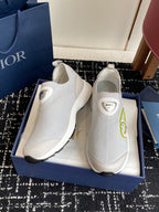 White slip-on sneakers with neon-green logo, thick rubber sole and Dior label
