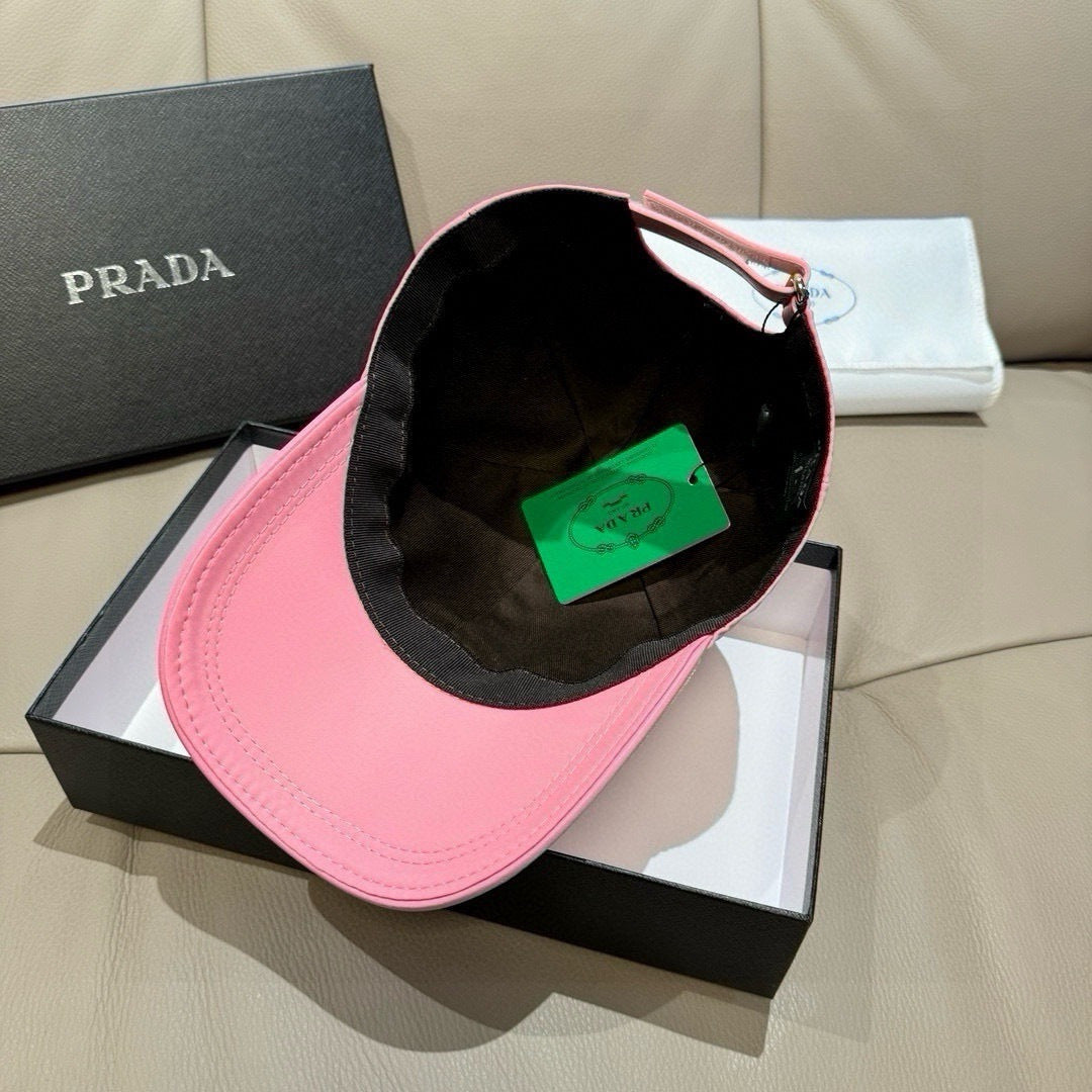 Prada cap inside view showing black inner lining and green tag, pink brim.