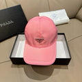 Prada pink cap with triangular logo patch at front, curved brim, stitched panels.