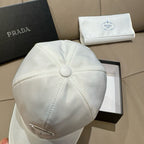 White baseball cap with stitched crown and small round button on top.