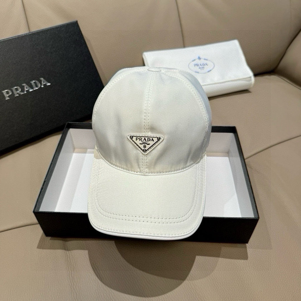 White baseball cap with Prada triangular logo patch on front panel.