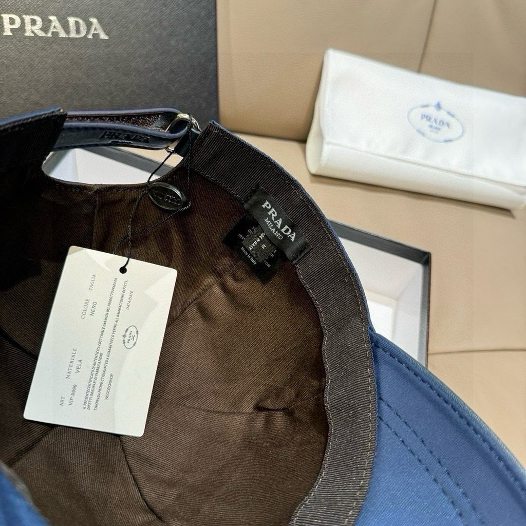 Prada cap interior with dark lining, adjustable strap, and hanging product tag.