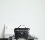 Chanel quilted handbag with top handle and chain strap, black