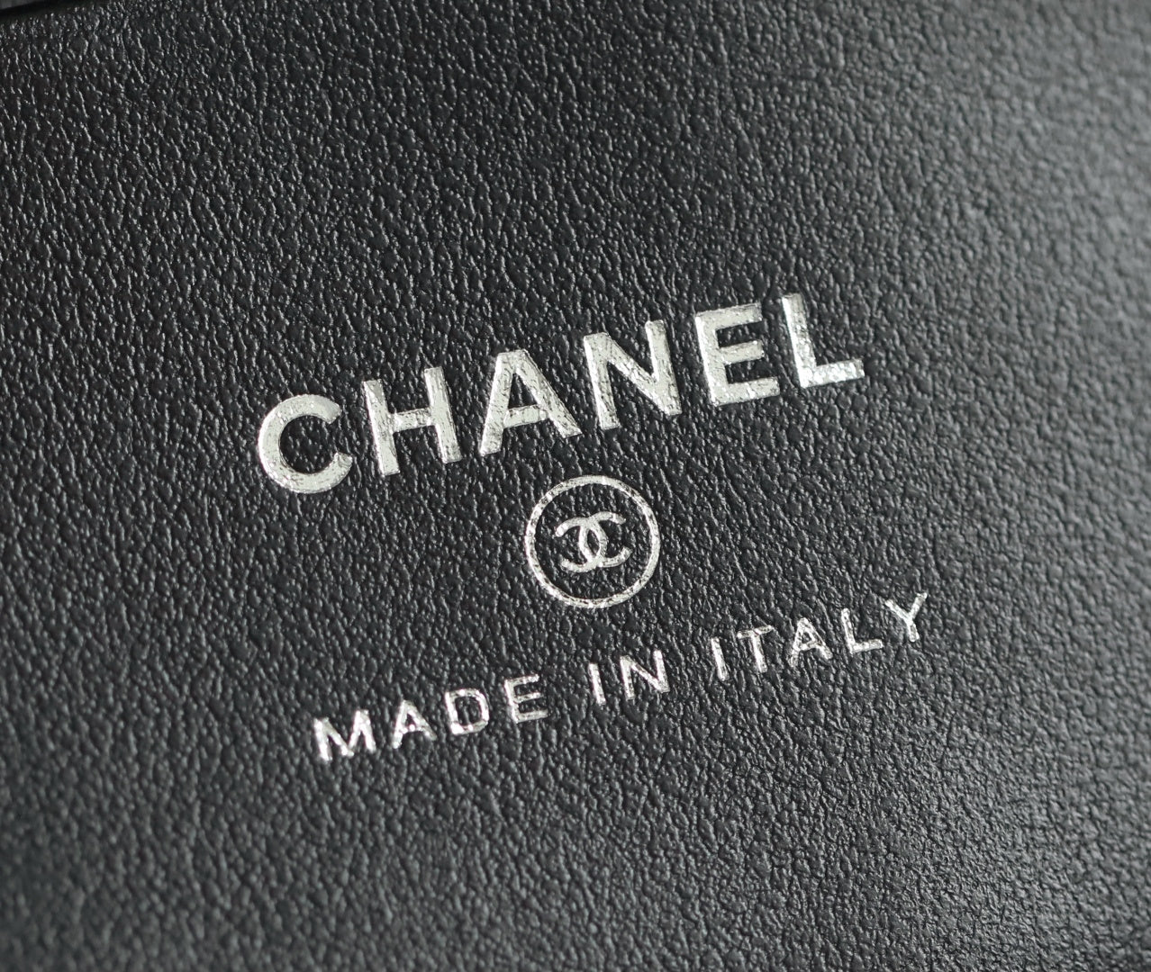 Chanel logo and "Made in Italy" stamped on black leather lining