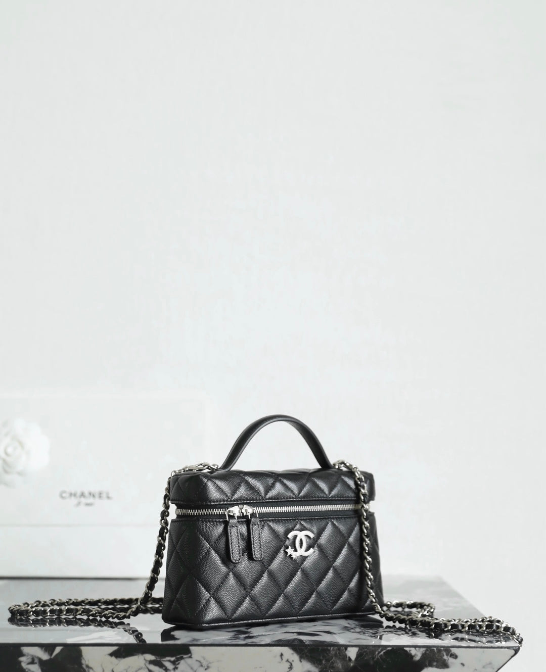 Chanel quilted handbag with chain strap and front logo emblem, black
