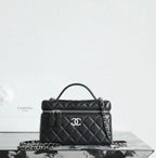 Chanel quilted handbag with top handle, chain strap, and front zipper