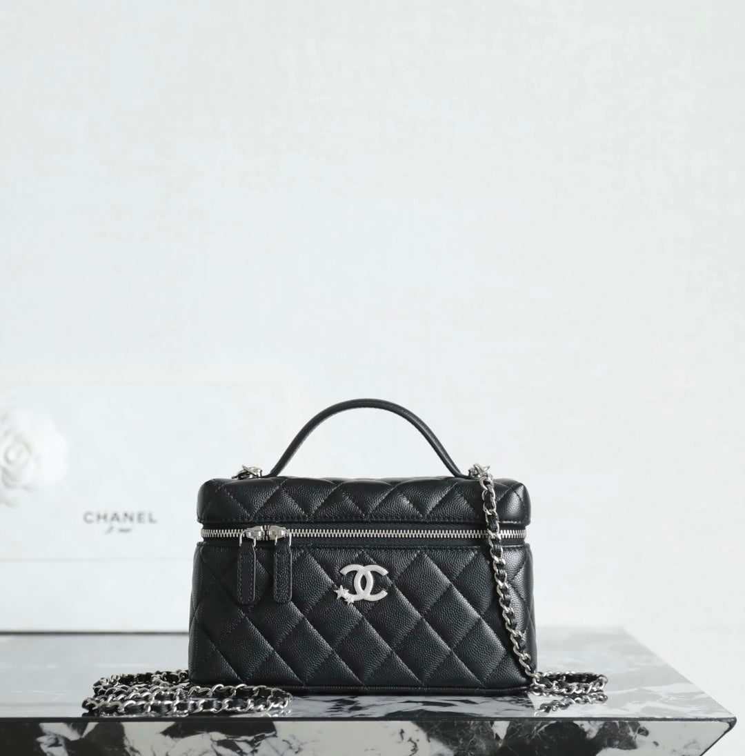 Chanel quilted handbag with top handle, chain strap, and front zipper