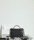 Chanel quilted handbag with top handle and chain strap, black