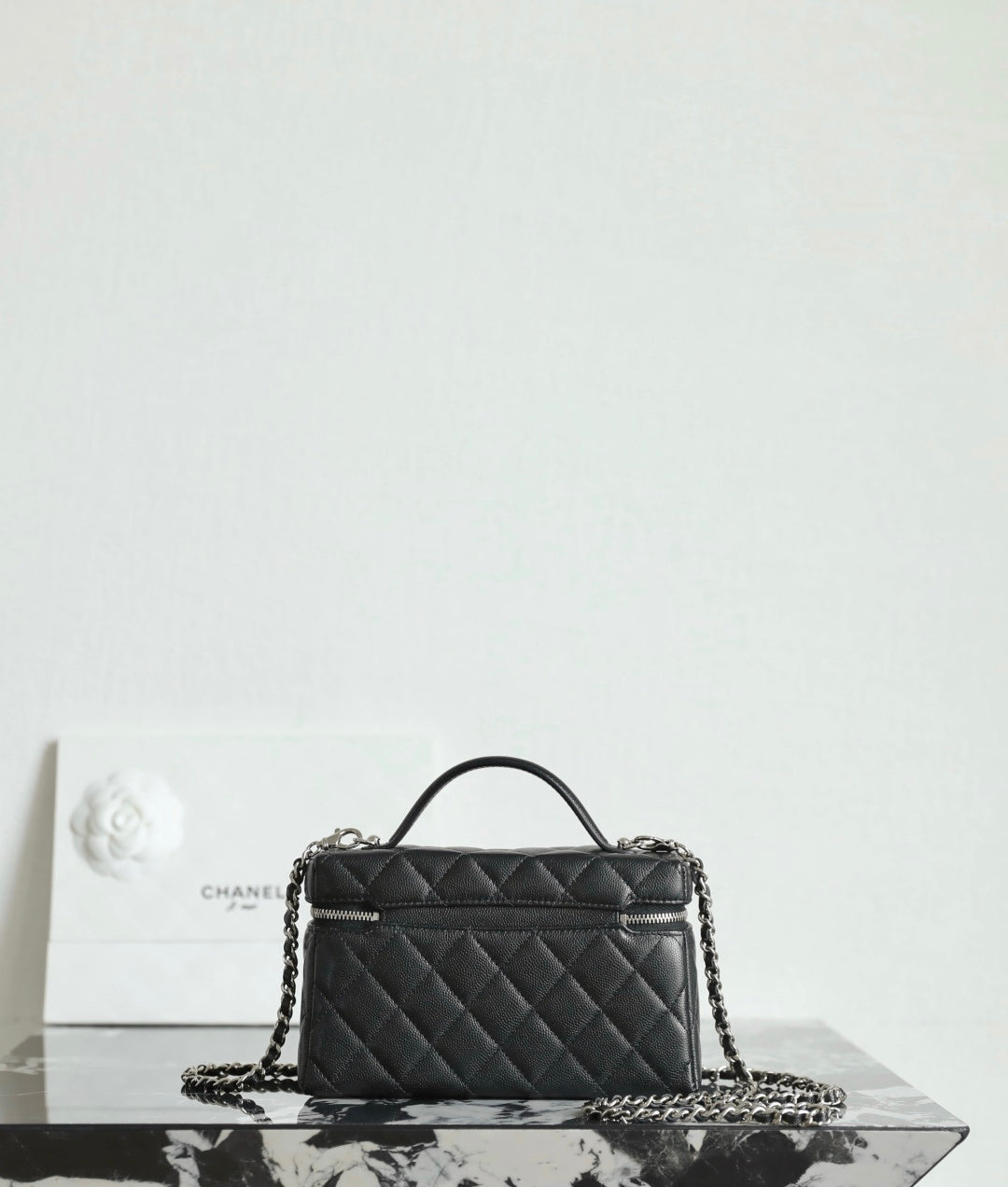 Chanel quilted handbag with top handle and chain strap, black