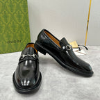 Gucci unisex leather loafer shoes in black, angled pair view, horsebit strap