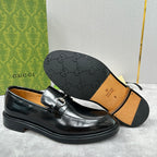 Gucci unisex leather loafer shoes in black, outsole view with embossed pattern