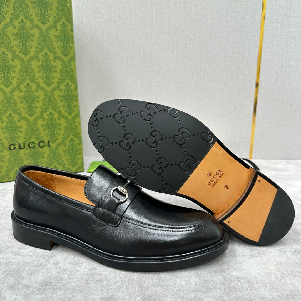 Gucci unisex loafers outsole, black leather upper, patterned rubber tread shown.