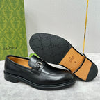 Gucci unisex loafers outsole, black leather upper, patterned rubber tread shown.