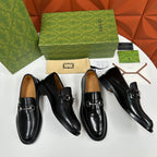 Gucci leather loafers, black with silver horsebit; four loafers arranged