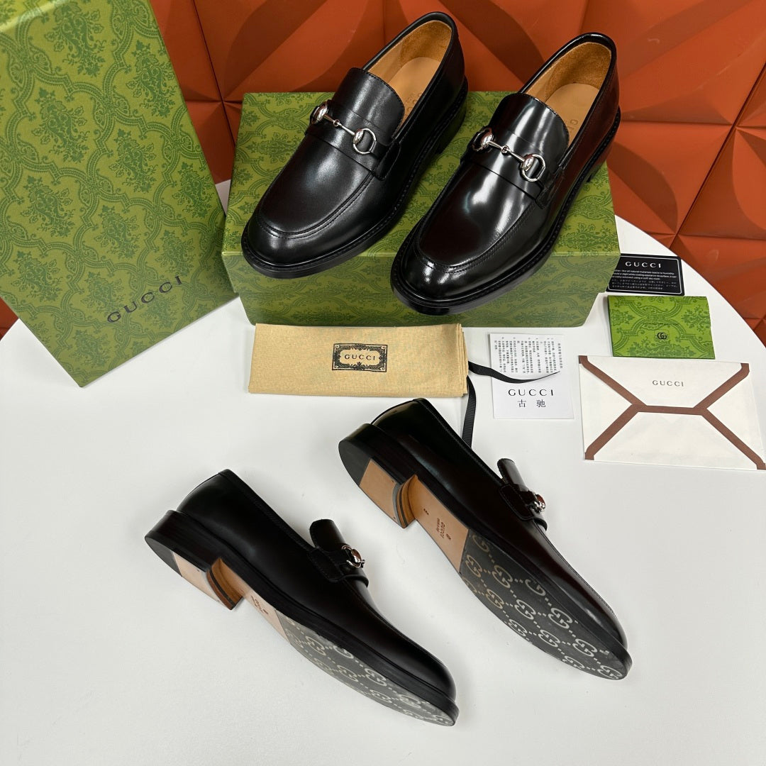Gucci leather loafers, black with silver horsebit, two pairs on display
