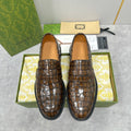 Gucci unisex loafers in brown crocodile-embossed leather with strap detail