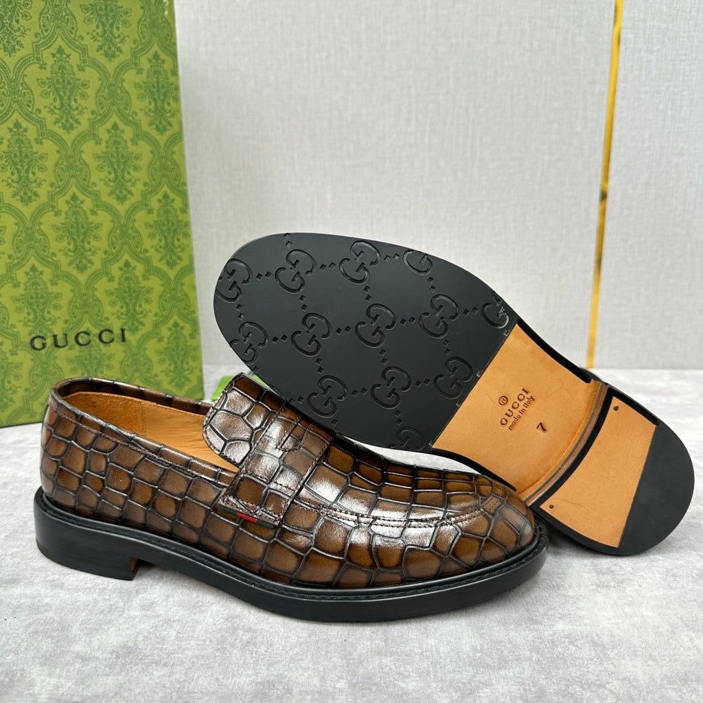 Gucci loafers bottom and side view: dark outsole with textured leather upper