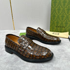 Brown crocodile-embossed Gucci loafers with square toe and tassel-free strap