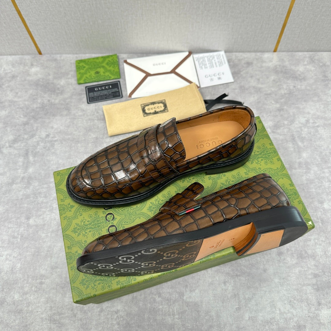 Gucci loafers with brown crocodile-embossed finish, shown front and side views