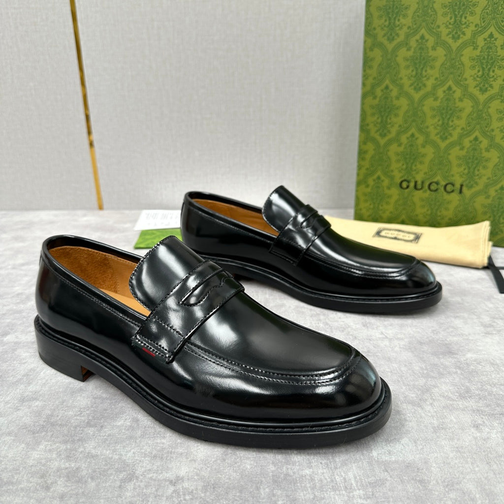 Unisex black leather loafers with strap front and low heel