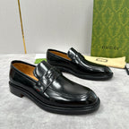 Unisex black leather loafers with strap front and low heel