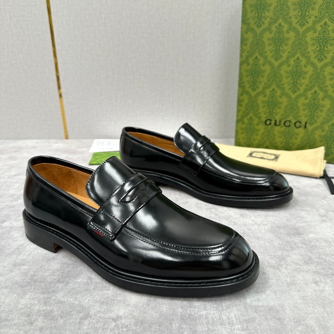 Unisex black leather loafers with strap front and low heel