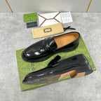 Unisex black leather loafers with strap detail and tan lining visible