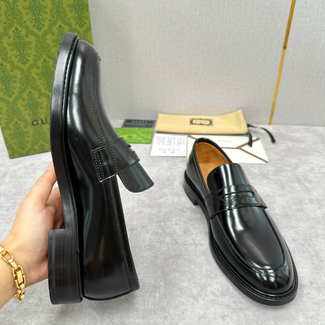 Unisex black leather loafers, side profile with low block heel