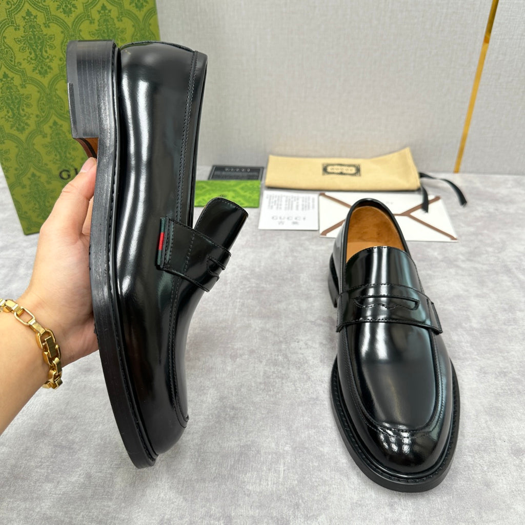 Unisex black leather loafers, side view with strap and stitched panels