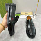 Unisex black leather loafers, side view with strap and stitched panels