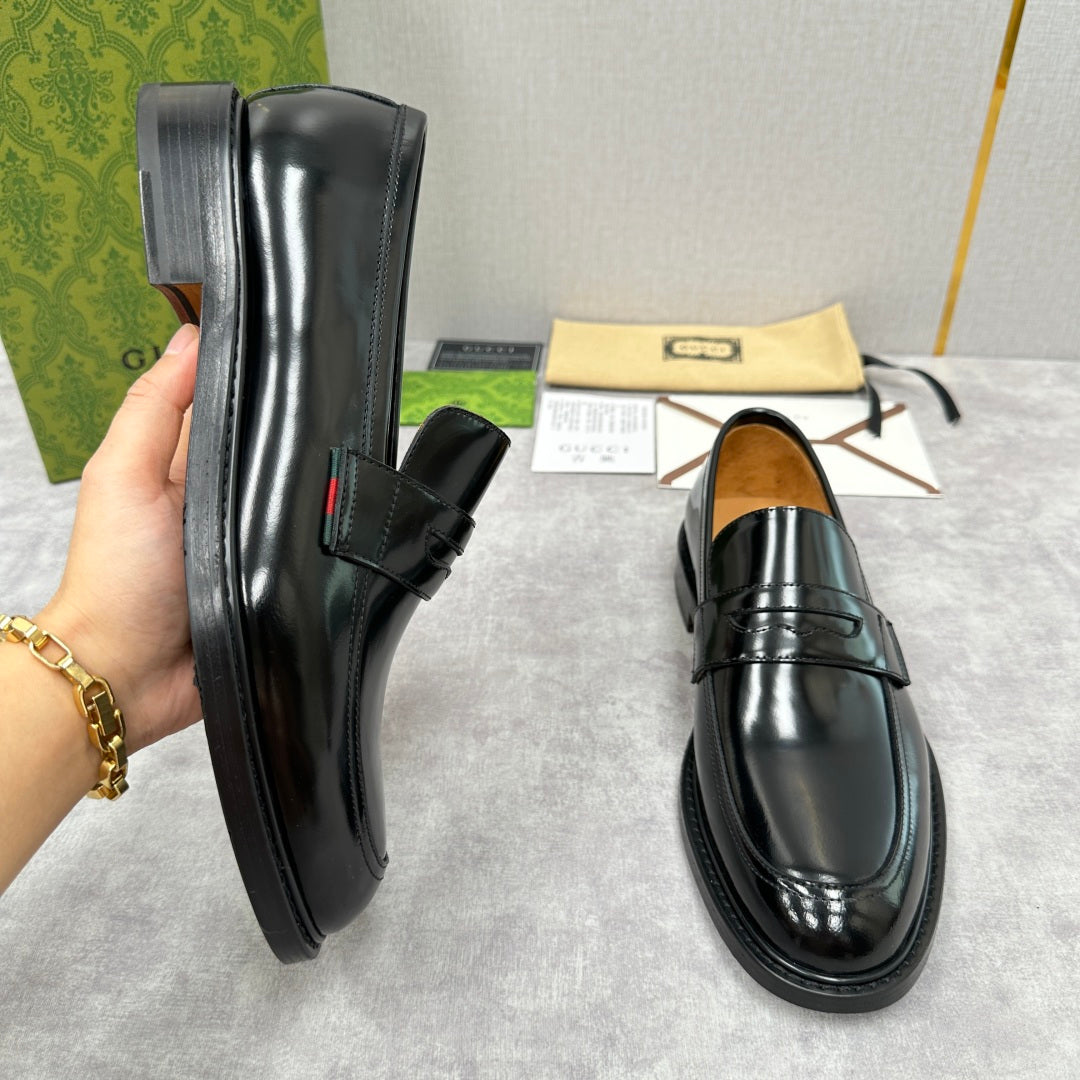 Unisex black leather loafers, side view with strap and stitched panels